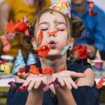 portrait-teenage-girl-blowing-confetti-her-birthday